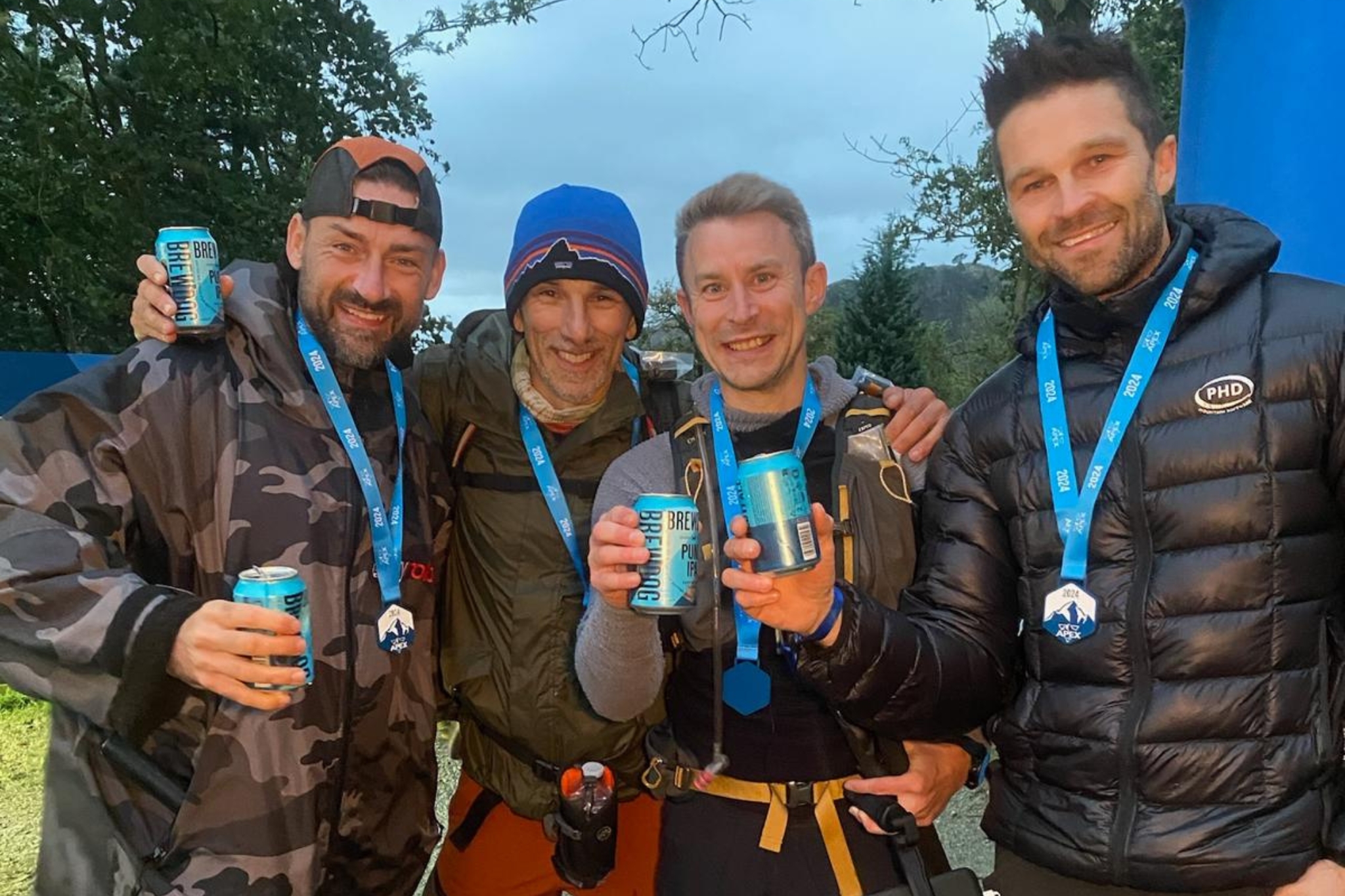 people celebrating finishing APEX everest event with beers and award medals